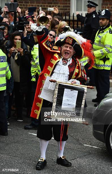 Town crier Tony Appleton makes an announment of the birth of Catherine, Duchess of Cambridge and Prince William's second child, a daughter, outside...