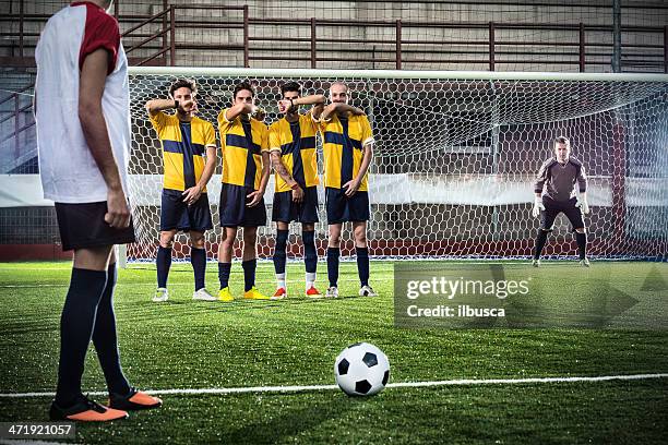 football match in stadium: free kick - defender soccer stock pictures, royalty-free photos & images