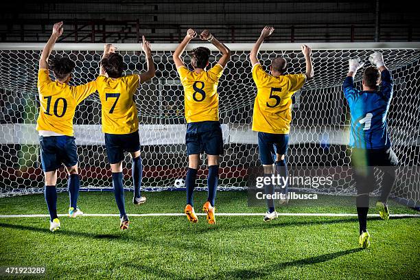 football match in stadium: end of game celebration - försvarare fotbollsspelare bildbanksfoton och bilder