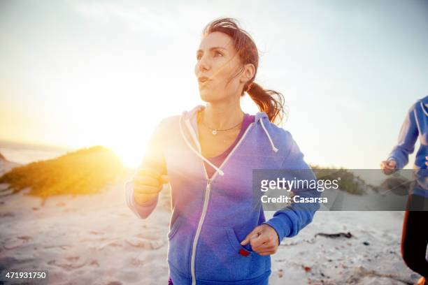 woman running on the beach - 2015 40 stock pictures, royalty-free photos & images