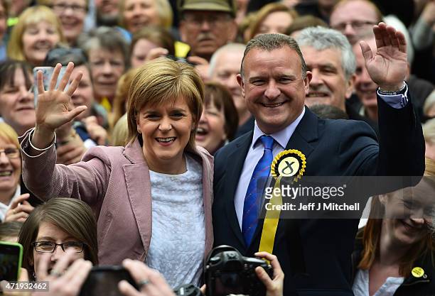 First Minister and leader of the SNP Nicola Sturgeon and Scottish National Party councillor and Council Leader Drew Hendry wave as they visit by...