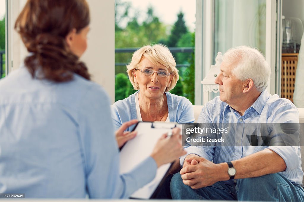 Senior couple talking with insurance agent