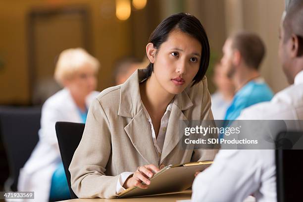 young asian businesswoman conducting interview to hire employee - nurse recruitment stock pictures, royalty-free photos & images