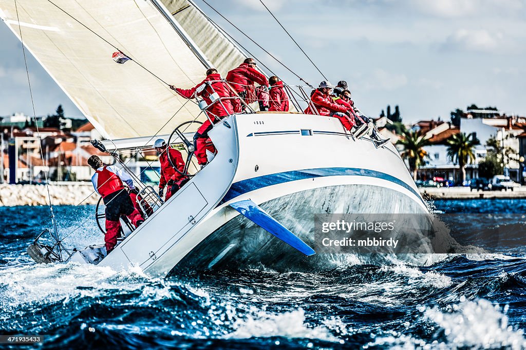 Sailing crew on sailboat during regatta