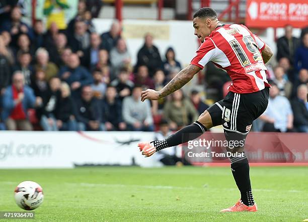 Andre Gray of Brentford scores his team's third goal during the Sky Bet Championship match between Brentford and Wigan Athletic at Griffin Park on...