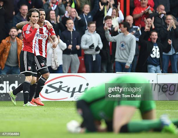 Andre Gray of Brentford celebrates his goal with his team-mate Jota during the Sky Bet Championship match between Brentford and Wigan Athletic at...