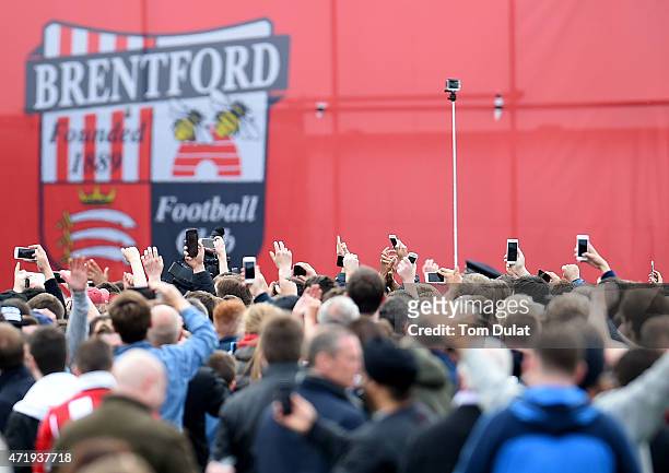 Brentford logo is pictured while the fans use their phones during the Sky Bet Championship match between Brentford and Wigan Athletic at Griffin Park...