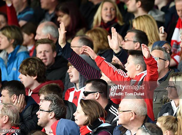 Brentford fans celebrate during the Sky Bet Championship match between Brentford and Wigan Athletic at Griffin Park on May 2, 2015 in Brentford,...