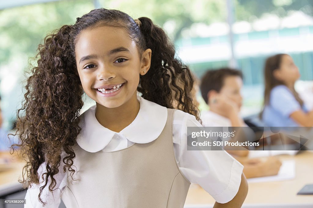 Adorable mixed race student in private school uniform