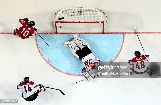 Andres Ambuhl of Switzerland scores his team's 2nd goal over Bernhard Strabaum, goaltendet of Austria during the IIHF World Championship group A...