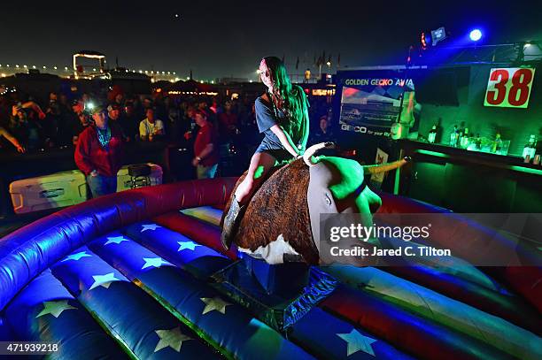 Fan rides a mechanical bull on the infield at Talladega Superspeedway on May 1, 2015 in Talladega, Alabama.