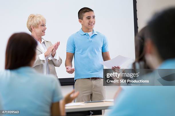 private high school student giving speech in front of classroom - boy giving speech stock pictures, royalty-free photos & images