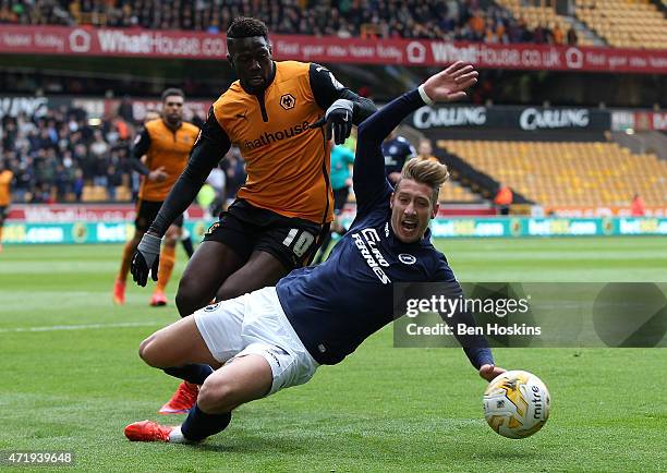 Lee Martin of Millwall goes down under pressure from Bakary Sako of Wolves during the Sky Bet Championship match between Wolverhampton Wanderers and...