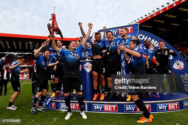 Tommy Elphick of Bournemouth lifts the trophy while Bournemouth players celebrate winning the Championship after the Sky Bet Championship match...