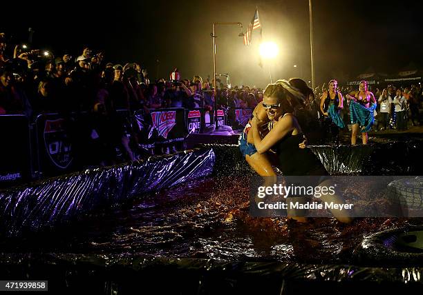 Fans wrestle in barbecue sauce on the infield at Talladega Superspeedway on May 1, 2015 in Talladega, Alabama.