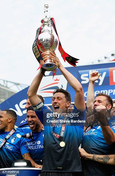 Tommy Elphick of Bournemouth lifts the trophy while Bournemouth players celebrate winning the Championship after the Sky Bet Championship match...