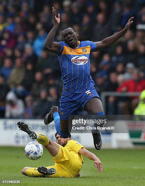 Jermaine Grandison of Shrewsbury Town is fouled by Bobby Reid of Plymouth Argyle during the Sky Bet League Two match between Shrewsbury Town and...