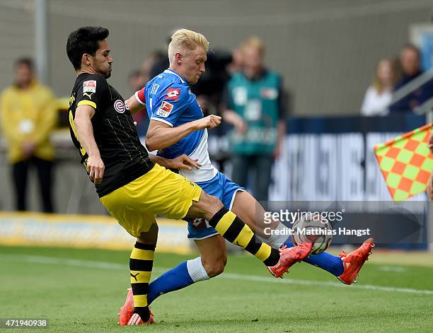Andreas Beck of Hoffenheim is challenged by Ilkay Guendogan of Dortmund during the Bundesliga match between 1899 Hoffenheim and Borussia Dortmund at...