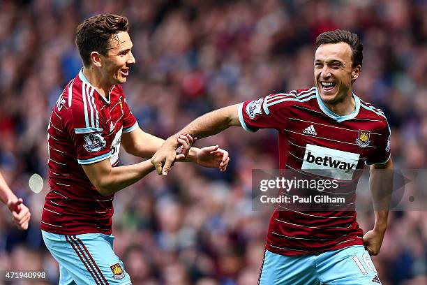 Mark Noble of West Ham United celebrates scoring his team's first goal from the penalty spot with his team mate Stewart Downing during the Barclays...