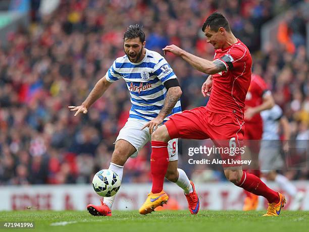 Charlie Austin of QPR is challenged by Dejan Lovren of Liverpool during the Barclays Premier League match between Liverpool and Queens Park Rangers...