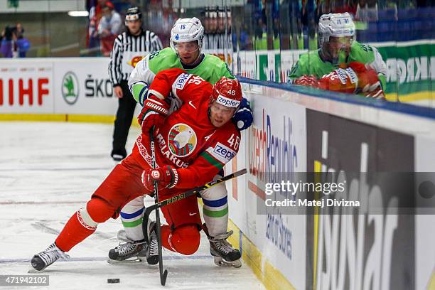 Andrei Kostitsyn of Belarus and Ales Music of Slovenia battle for the puck during the IIHF World Championship group B match between Belarus and...