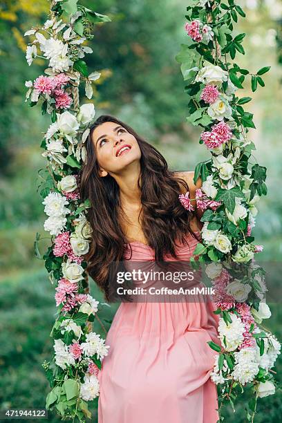 beautiful young girl on a swing - woman pink dress stock pictures, royalty-free photos & images