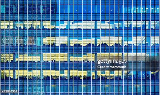 office windows in the night - london docklands at night stock pictures, royalty-free photos & images
