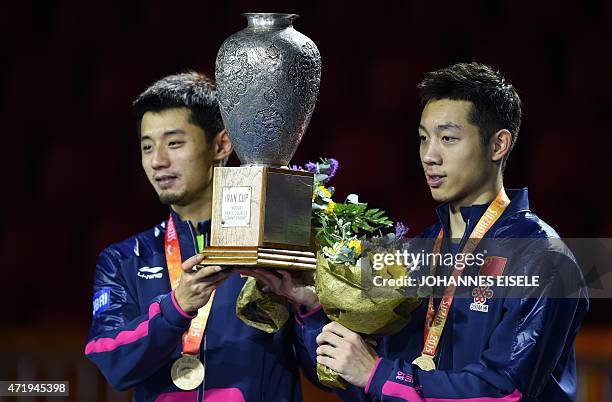 Xu Xin and Zhang Jike of China pose with their trophy after winning the men's doubles final match against Fan Zhendong and Zhou Yu of China at the...