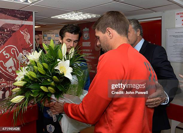 Steven Gerrard of Liverpool and Joey Barton of Queens Park Rangers present flowers in honour of the passing of Rebecca Ferdinand before the Barclays...