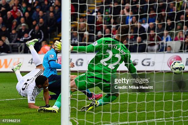 Jefferson Montero of Swansea City scores his team's first goal past Jack Butland of Stoke City during the Barclays Premier League match between...
