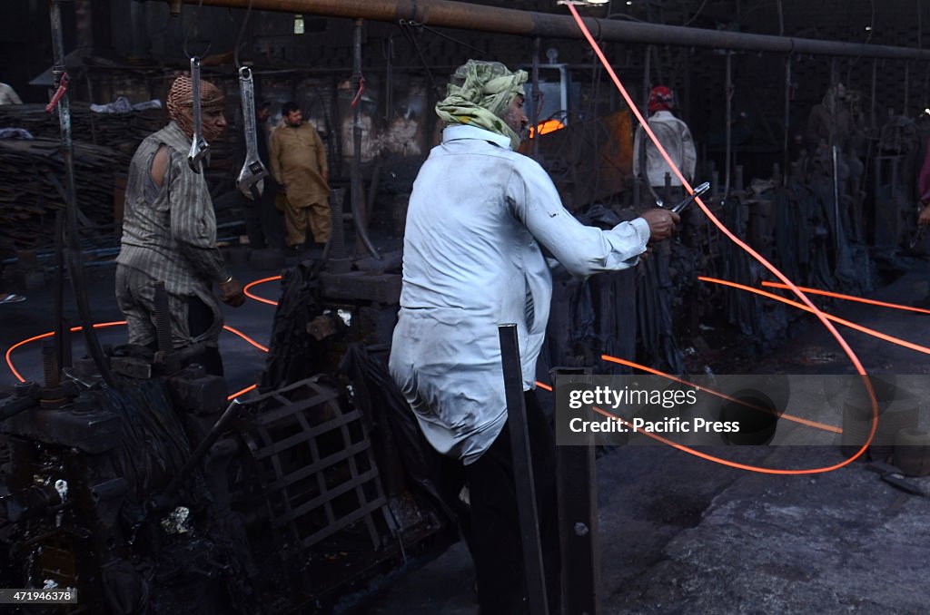 Pakistani blacksmiths are busy melting steel and shaping...