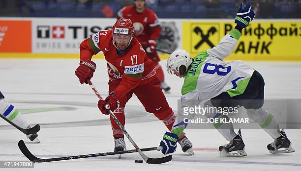 Slovenia's goalkeeper Ziga Jeglic tries to stop Alexei Kaluzhny of Belarus during the group B preliminary round ice hockey match Belarus vs Slovenia...