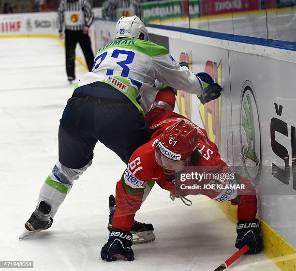 Slovenia's Luka Vidmar tackles Andrei Stepanov of Belarus during the group B preliminary round ice hockey match Belarus vs Slovenia of the IIHF...