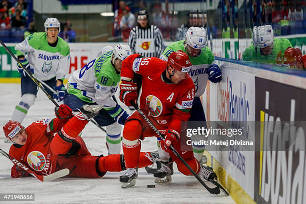 Andrei Kostitsyn of Belarus and Ales Music of Slovenia battle for the puck during the IIHF World Championship group B match between Belarus and...