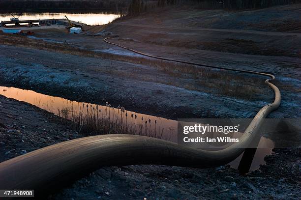 Water intake pipe for oil sands operations leads downhill to the Athabasca River on April 28th, 2015 north of Fort McMurray, Canada. Fort McMurray is...