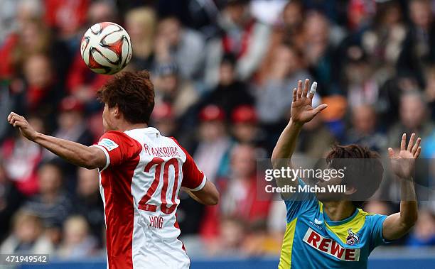 Jeong-Ho Hong of Augsburg and Yuya Osako of Koeln jump for a header during the Bundesliga match between FC Augsburg and 1. FC Koeln at SGL Arena on...