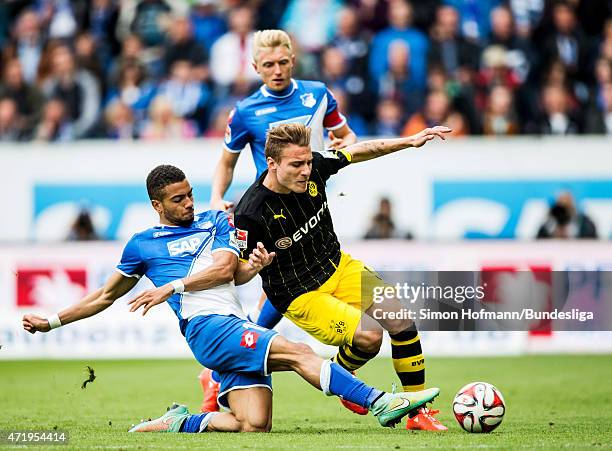 Ciro Immobile of Dortmund is challenged by Jeremy Toljan of Hoffenheim during the Bundesliga match between 1899 Hoffenheim and Borussia Dortmund at...