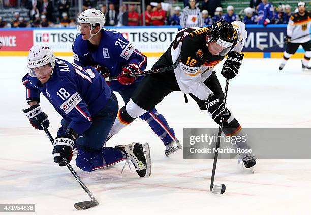 Yohann Auvitu of France and Michael Wolf of Germnay battle for the puck during the IIHF World Championship group A match between France and Germany...