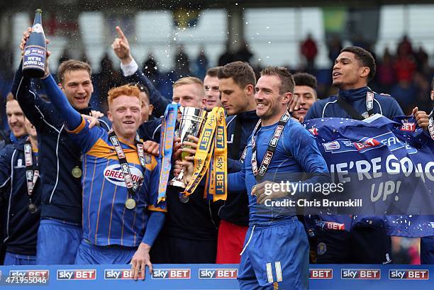 Liam Lawrence of Shrewsbury Town lifts the runners up trophy to celebrate promotion following the Sky Bet League Two match between Shrewsbury Town...