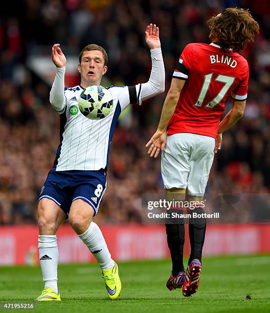 Craig Gardner of West Brom is closed down by Daley Blind of Manchester United during the Barclays Premier League match between Manchester United and...