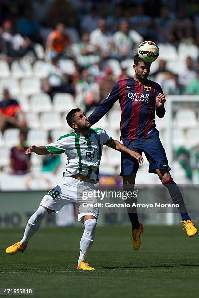 Gerard Pique of FC Barcelona wins the header before Forin Andone of Cordoba CF during the La Liga match between Cordoba CF and Barcelona FC at El...