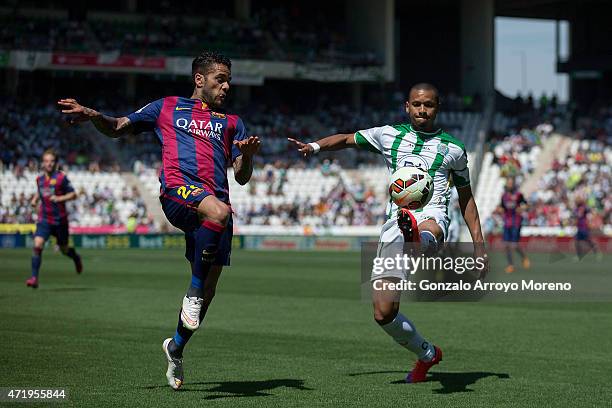Dani Alves of FC Barcelona competes for the ball with Edimar Fraga of Cordoba CF during the La Liga match between Cordoba CF and Barcelona FC at El...