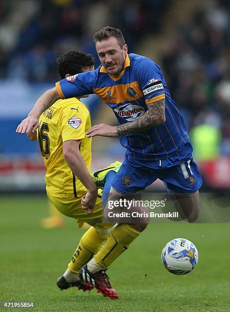 Liam Lawrence of Shrewsbury Town in action with Carl McHugh of Plymouth Argyle during the Sky Bet League Two match between Shrewsbury Town and...