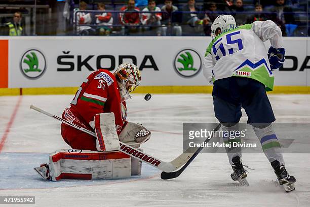 Robert Sabolic of Slovenia tries to score against Kevin Lalande, goalkeeper of Belarus, during the IIHF World Championship group B match between...