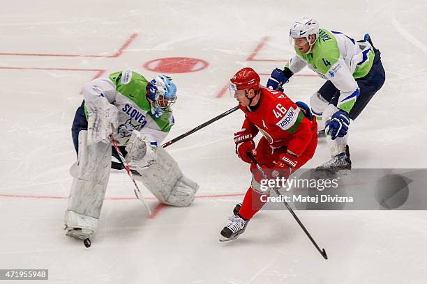 Andrei Kostitsyn of Belarus and Robert Kristian , goalkeeper of Slovenia, battle for the puck during the IIHF World Championship group B match...