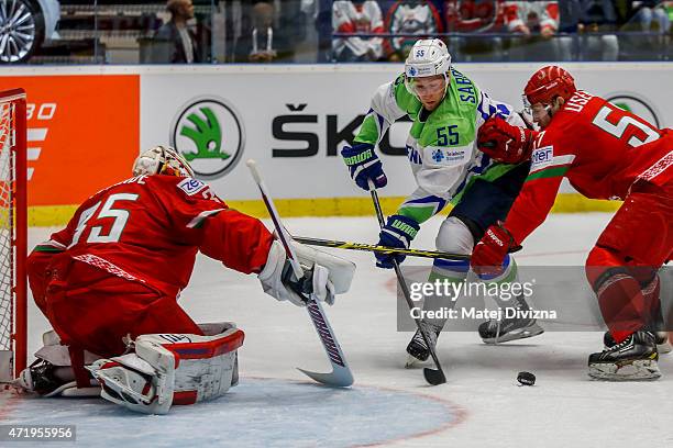 Robert Sabolic of Slovenia tries to score against Kevin Lalande, goalkeeper of Belarus, during the IIHF World Championship group B match between...