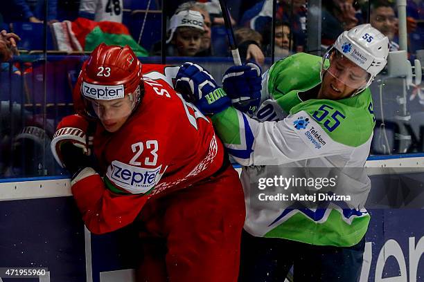 Andrei Stas of Belarus and Robert Sabolic of Slovenia battle during the IIHF World Championship group B match between Belarus and Slovenia at CEZ...