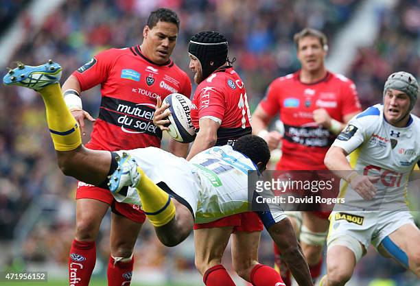 Matt Giteau of Toulon evades the flying tackle from Naipolioni Nalaga of Clermont during the European Rugby Champions Cup Final match between ASM...