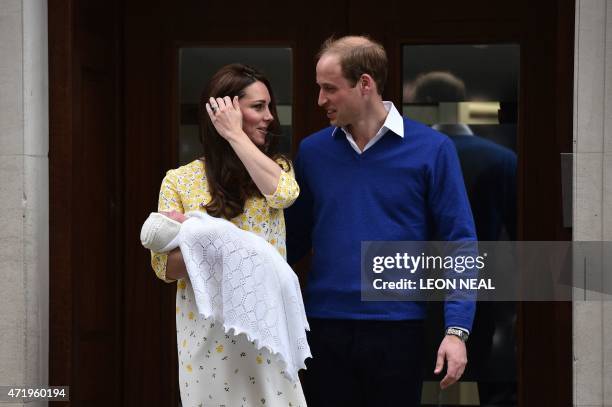 Britain's Prince William, Duke of Cambridge, looks towards his wife Catherine, Duchess of Cambridge as they show their newly-born daughter, their...