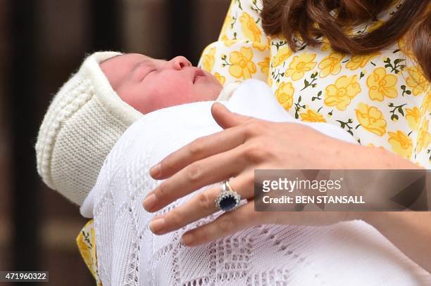 Britain's Catherine, Duchess of Cambridge holds her newly-born daughter, her second child with Britain's Prince William, Duke of Cambridge, as they...